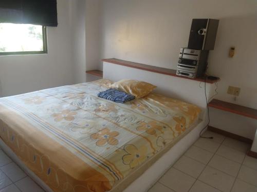 a bedroom with a large bed with a television on it at Habitaciones con baño privado en Departamento compartido en Club Santiago Manzanillo in Manzanillo