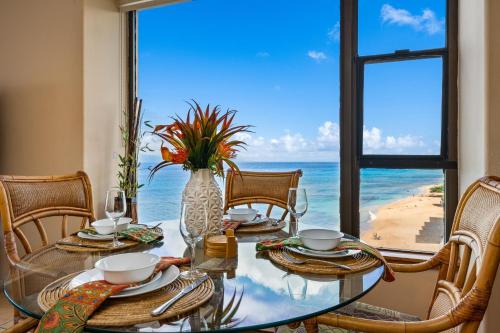 a dining room with a table with a view of the ocean at Maui Kai 808 · MK 808 OceanFront 1BD Kaanapali Beach Ocean Views in Lahaina