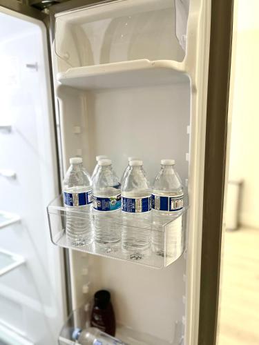 a group of water bottles in an open refrigerator at NEW cozy beautiful house with pool and hot tub in Fair Oaks