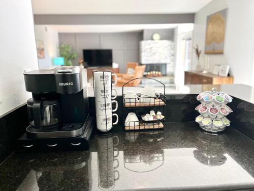 a kitchen counter with a coffee maker on a counter top at NEW cozy beautiful house with pool and hot tub in Fair Oaks
