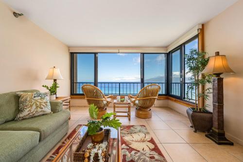 a living room with a couch and a table and chairs at Maui Kai 808 · MK 808 OceanFront 1BD Kaanapali Beach Ocean Views in Lahaina