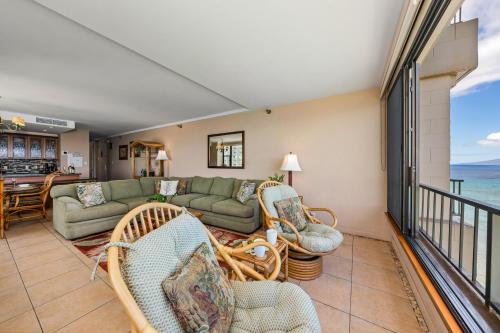 a living room with a couch and chairs and the ocean at Maui Kai 808 · MK 808 OceanFront 1BD Kaanapali Beach Ocean Views in Lahaina