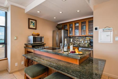 a kitchen with a counter and a microwave at Maui Kai 808 · MK 808 OceanFront 1BD Kaanapali Beach Ocean Views in Lahaina