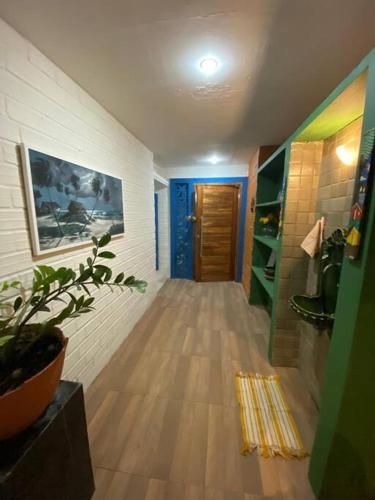 a hallway of a room with a wooden floor at Ampla casa de 3 quartos com piscina em Serrambi PE a 50mts do mar in Porto De Galinhas