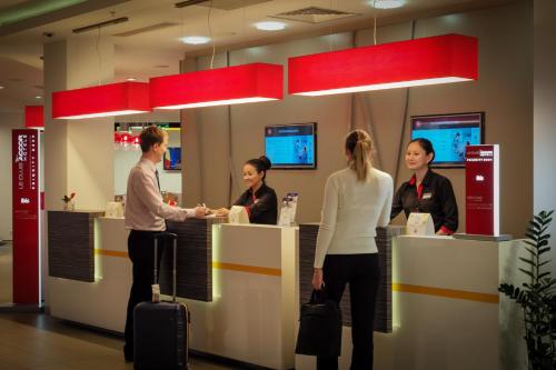 a group of people standing at a counter in a store at Ibis Astana in Astana