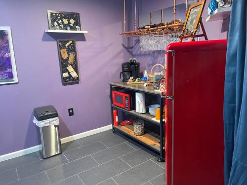 a kitchen with a red refrigerator and purple walls at Maxine Manor in Douglasville