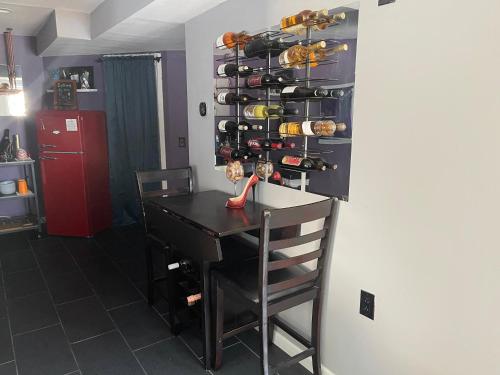 a kitchen with a table and a shelf with wine bottles at Maxine Manor in Douglasville