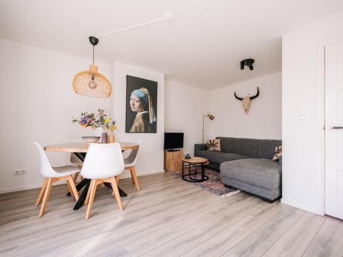 a living room with a table and a couch at Zandvoortferienwohnungen in Zandvoort