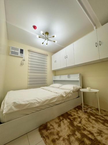 a bedroom with a bed and a ceiling fan at La Casa De Lita in Manila