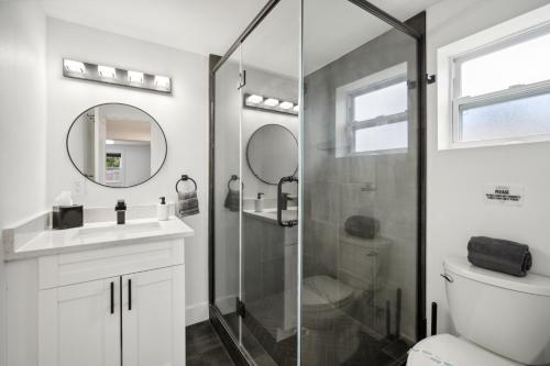 a bathroom with a shower and a toilet and a sink at 3Bd 2Ba House with Parking Laundry and Large Patio in Largo