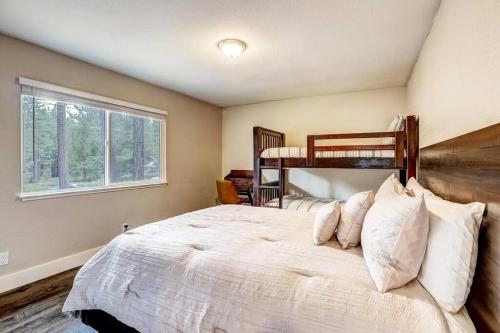 a bedroom with a large white bed with a window at Bear Cub Cabin - Pets - Hot tub - Arcade Game in Mevers