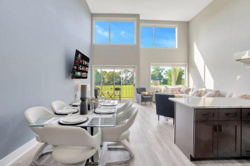 a dining room and living room with a table and chairs at Luxe Condo Overlooking Park in Birmingham