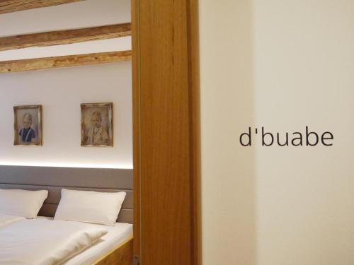 a room with a bed and a mirror with the words d bubble at Zum Hirschen - hotel & gasthaus beim stöckeler in Scheidegg