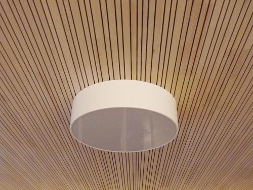 a white light fixture hanging from a ceiling at Zum Hirschen - hotel & gasthaus beim stöckeler in Scheidegg