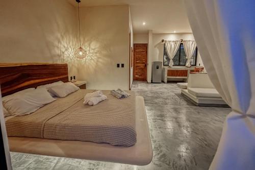 Ένα ή περισσότερα κρεβάτια σε δωμάτιο στο Casa Kobaab Tulum