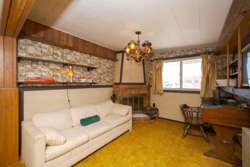 a living room with a white couch and a fireplace at Retro 70s Near MM103 Gap Trail in Star Junction