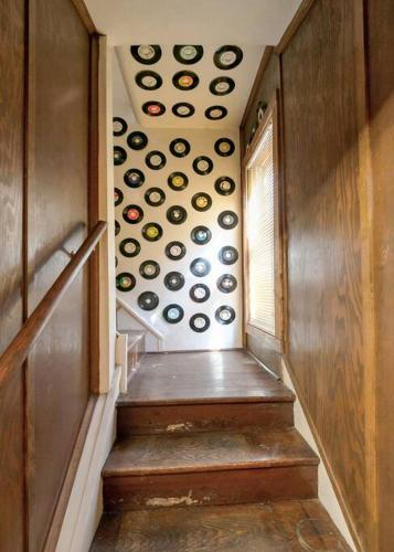a stairway with a bunch of plates on the wall at Retro 70s Near MM103 Gap Trail in Star Junction
