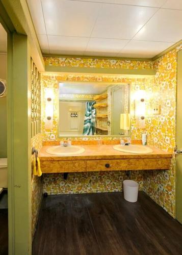 a bathroom with two sinks and a large mirror at Retro 70s Near MM103 Gap Trail in Star Junction