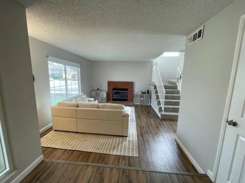 a living room with a couch and a fireplace at Pristine & Smart freshly remodeled house! in Lancaster