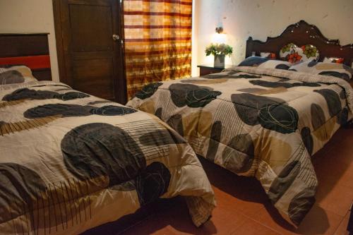 Postel nebo postele na pokoji v ubytování Hostal Cielo