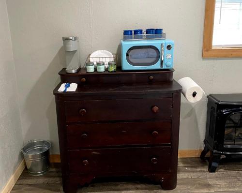 a microwave sitting on top of a dresser at Double D Guest Cottage in Emory