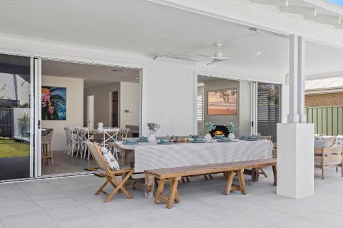 a dining room with a table and chairs at Welcome to Sandy Bottoms in Shoalhaven Heads