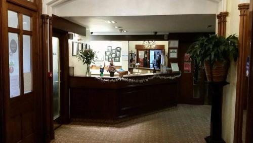 a lobby with a large mirror in a building at The Royal Hotel Tain in Tain