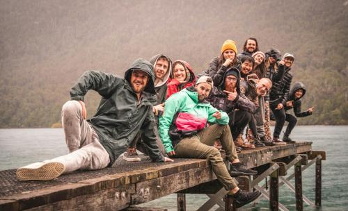 a group of people sitting on a pier at Ora Retreat in Queenstown