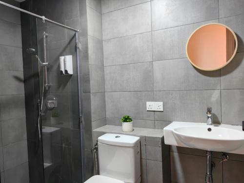 a bathroom with a toilet and a sink and a shower at Near Airport K Avenue Family Room in Donggongon