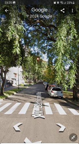 a street with a crosswalk with white arrows on the road at Amplia casa en planta alta en Av Mitre Parque Urquiza in Paraná