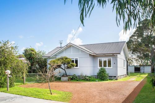 a white house with a tree in front of it at Silver Leaf Margaret River in Margaret River Town