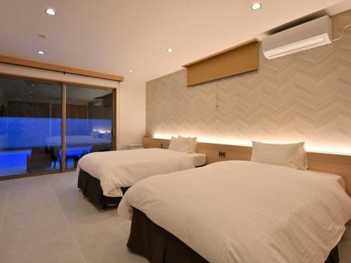 Una cama o camas en una habitación de SAKURA別邸 The Pool Villa