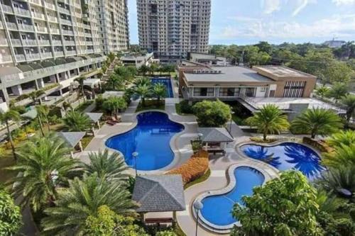 an aerial view of a resort with two pools at Verdon Parc 2 Bedroom with Balcony Amenity View in Davao City