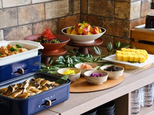 a buffet with different types of food on a table at hotel MONday Haneda Airport in Tokyo