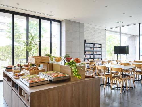 a restaurant with tables and chairs and a buffet at hotel MONday Haneda Airport in Tokyo