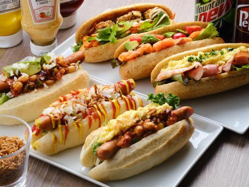 a group of hot dogs on a plate on a table at hotel MONday Haneda Airport in Tokyo