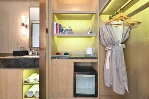 a kitchen with a sink and a shower curtain at Jingli Hotel Beijing Heshenghui Dajiaoting Subway Station Branch in Beijing