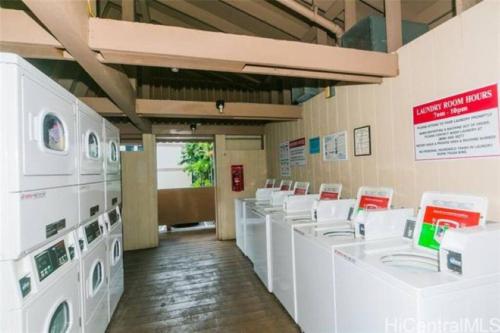 a laundry room with white washing machines on display at Valley Vibes and Beach Bliss Condo for Family Nomads in Waianae