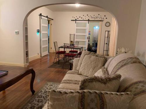a living room with a couch and a table at Comfortable 2-Bdrm Spacious Home with Wifi & Patio in Indianapolis