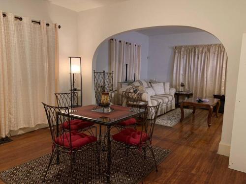 a living room with a table and a couch at Comfortable 2-Bdrm Spacious Home with Wifi & Patio in Indianapolis