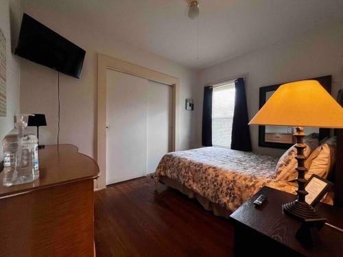 a bedroom with a bed and a lamp on a table at Comfortable 2-Bdrm Spacious Home with Wifi & Patio in Indianapolis