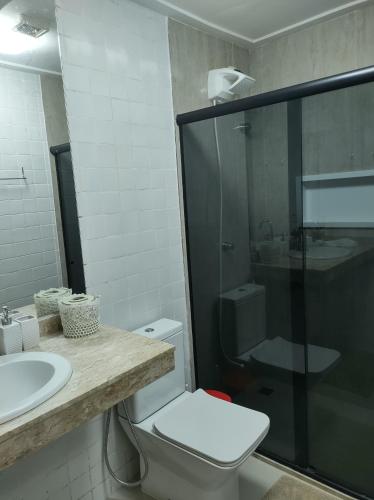 a bathroom with a toilet and a sink and a shower at Imbassaí in Imbassai