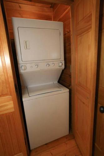 a small white refrigerator in a small room at Moon Willow - one level cabin with 2 master suites in Walnut Grove