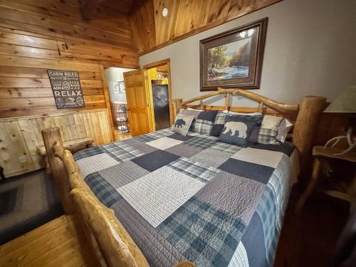 a bedroom with a bed in a log cabin at Moon Willow - one level cabin with 2 master suites in Walnut Grove