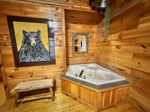 a bathroom with a tub in a wooden cabin at Moon Willow - one level cabin with 2 master suites in Walnut Grove