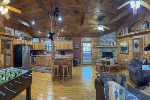 a large kitchen and living room in a log cabin at Moon Willow - one level cabin with 2 master suites in Walnut Grove