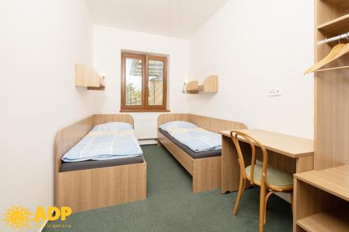a hospital room with two beds and a desk at Areál dobré pohody in Žimrovice