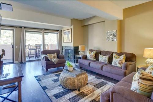 a living room with two couches and a fireplace at Beautiful views day and night! in Avalon