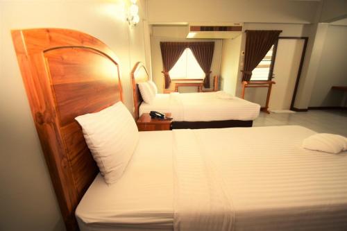 Postel nebo postele na pokoji v ubytování Best LD Hotel โรงแรมเบส แอลดี