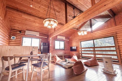 a dining room with a table and chairs in a cabin at VILLA ATAMI -Maruta- in Atami
